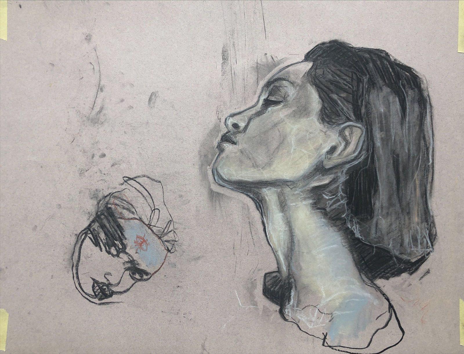 Profile with eyes closed in charcoal and chalk on pink paper, beside a loose sketch